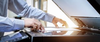 Business man Hand press button on panel of printer, printer scanner laser office copy machine supplies start